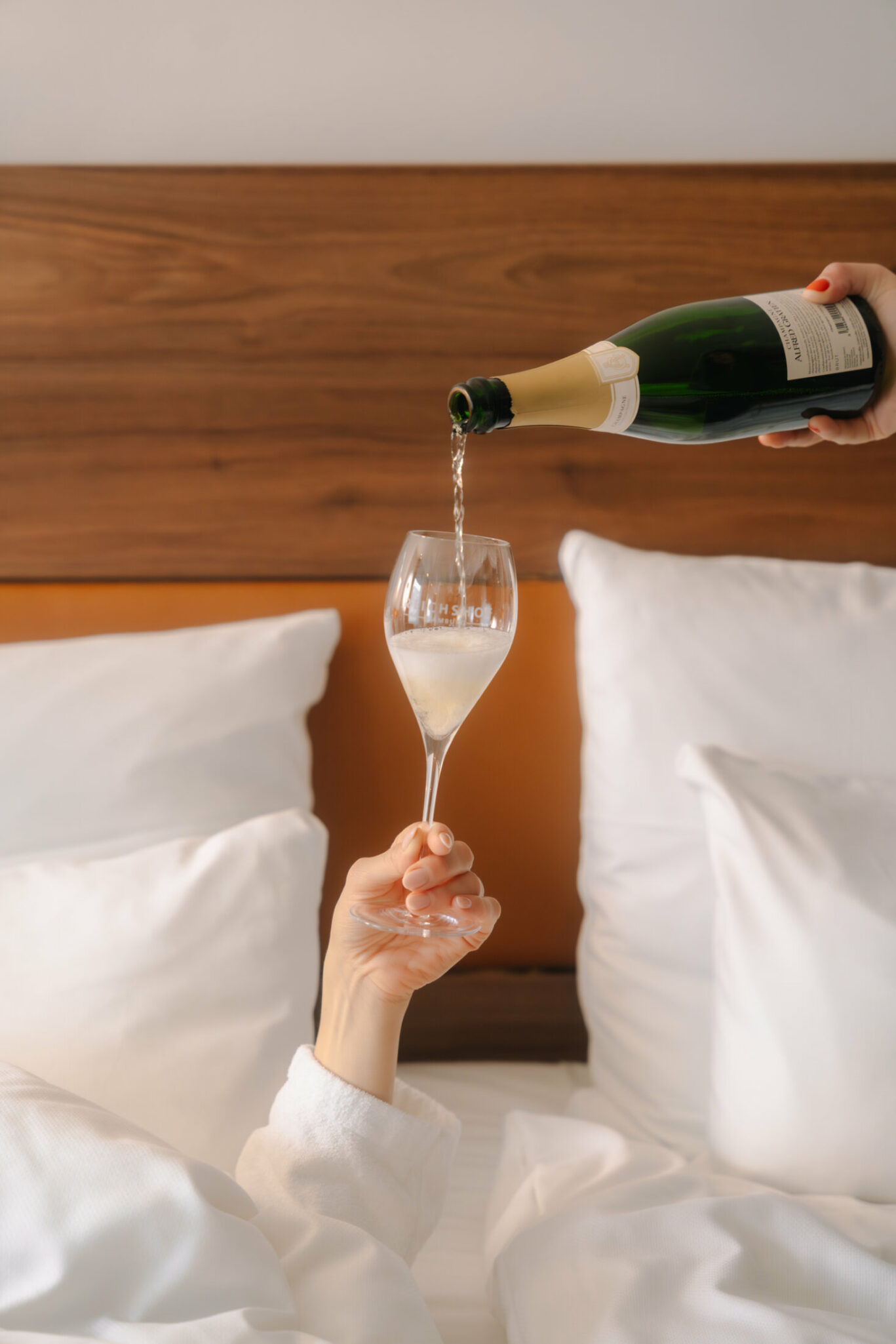 Woman holding up a glas of champagne