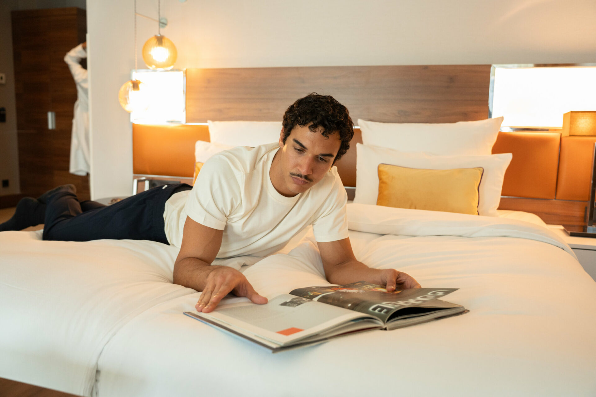 guest reading magazine in bed
