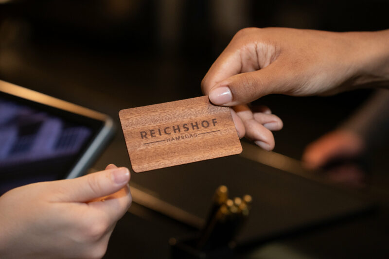 Receptionist handing over keycard to guest